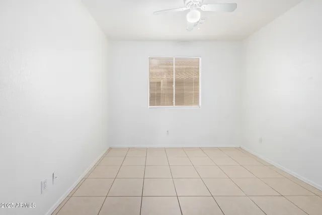 an empty room with a white cabinet and a window