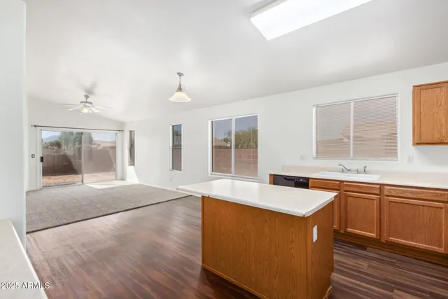 a large kitchen with stainless steel appliances granite countertop a sink and dishwasher a stove with wooden floor