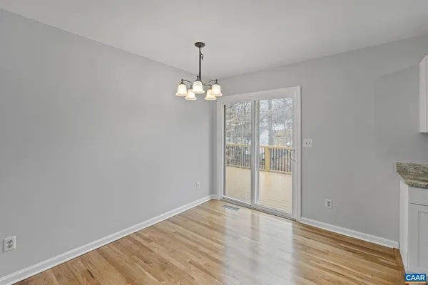 a kitchen with granite countertop white cabinets and a sink
