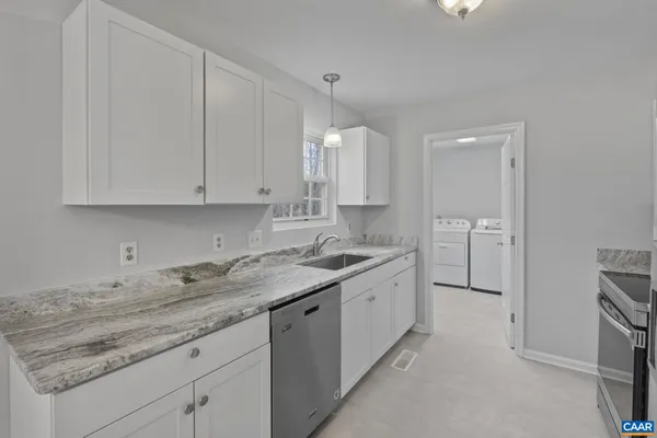 a white house that has a table and chairs in it