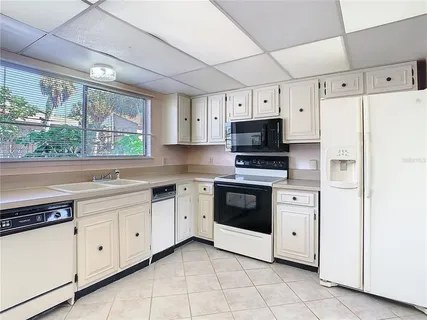 a kitchen with stainless steel appliances a stove sink and microwave