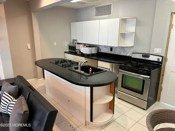 a kitchen with stainless steel appliances granite countertop a stove and a sink
