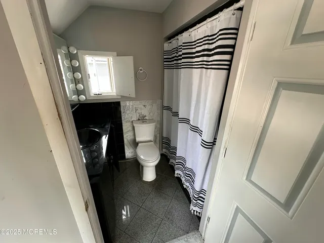 a bathroom with a sink a toilet and a shower