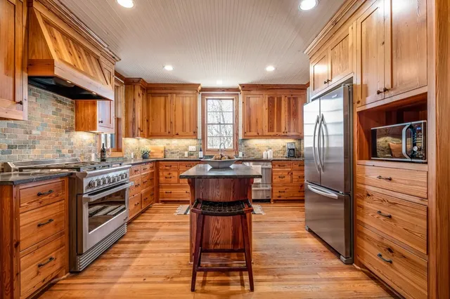 a spacious bathroom with a granite countertop sink a mirror and a shower