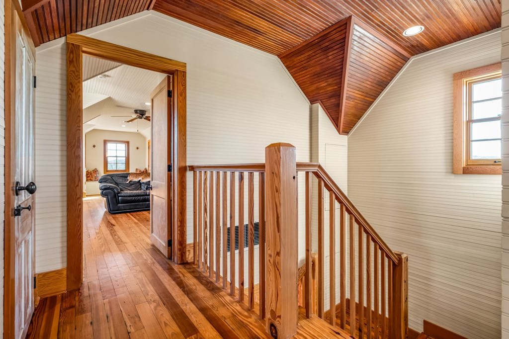 9402 Doss-Spring Creek Road Doss, TX 78618 - Photo 25 of 78 a view of a hallway view with wooden floor and staircase