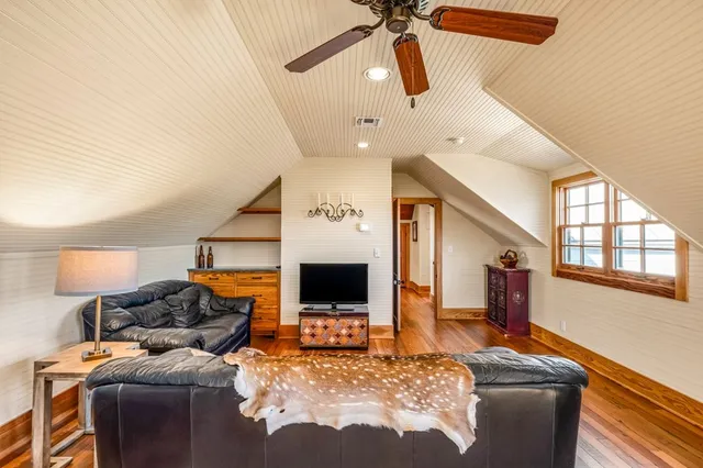 a bathroom with a granite countertop sink toilet and mirror