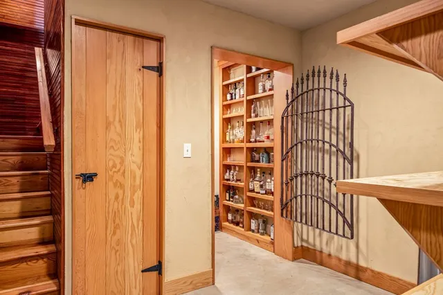 a front view of a house with large trees