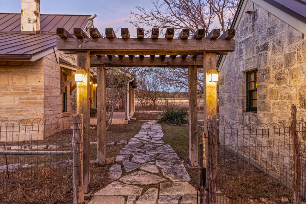 9402 Doss-Spring Creek Road Doss, TX 78618 - Photo 52 of 78 a view of a brick house with a glass door