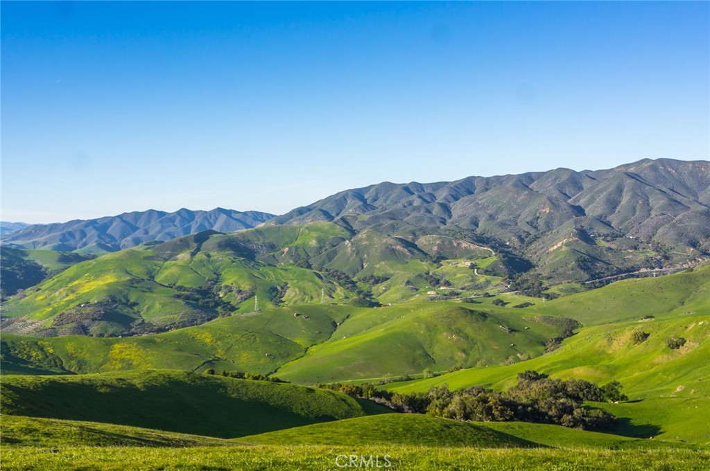 2440 Little Morro Creek Road Morro Bay, CA 93442 - Photo 4 of 39 a view of a lush green field with mountains in the background