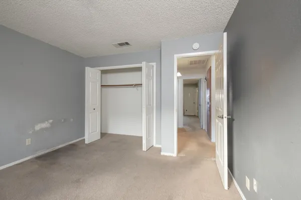 a view of an empty room and closet