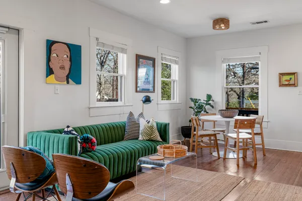 a living room with furniture and wooden floor