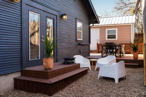 a front view of a house with outdoor seating