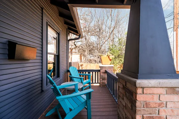 a kitchen with a sink and chairs