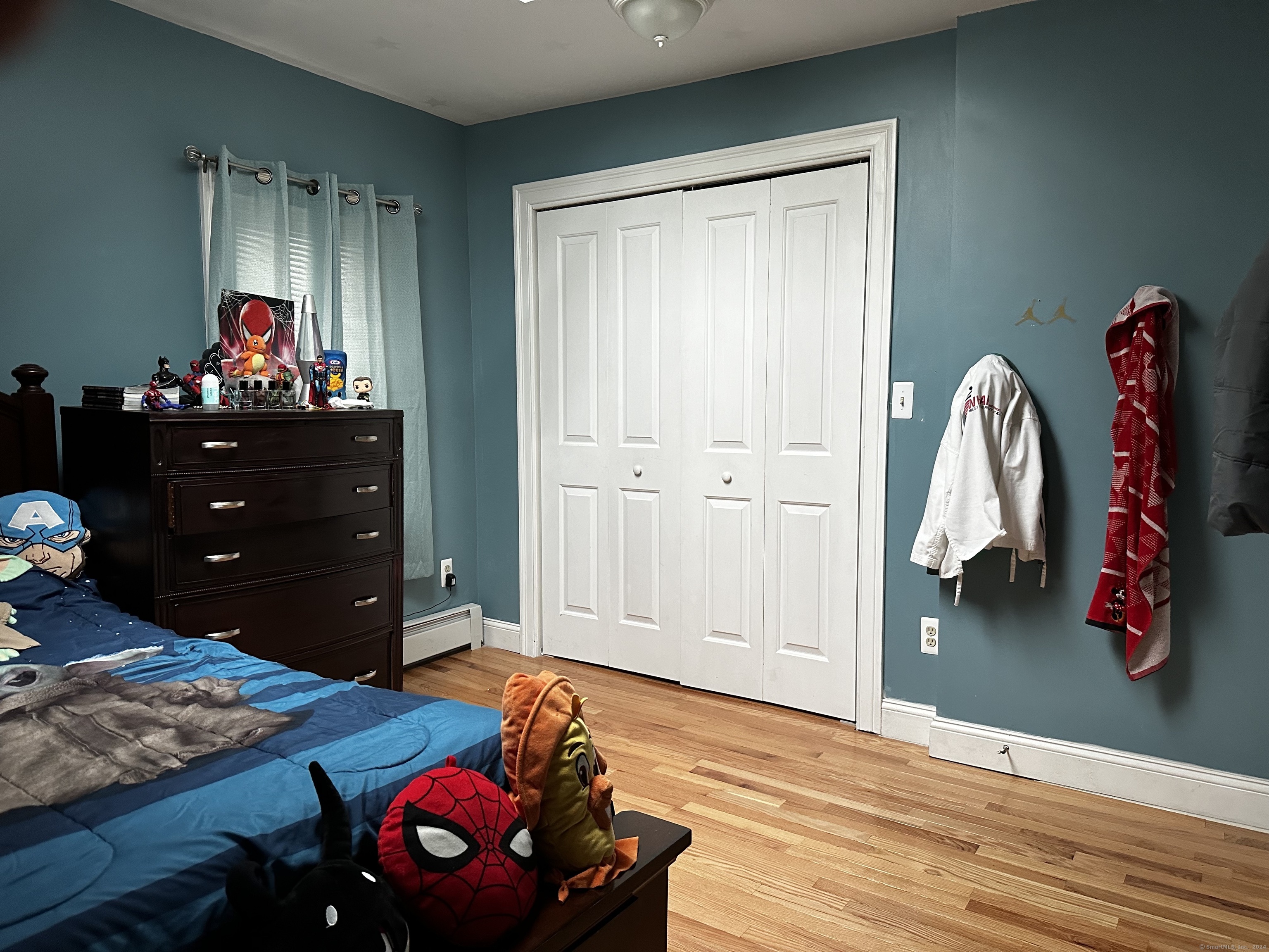 504 Dixwell Avenue New Haven, CT 06511 - Photo 16 of 26 a bedroom with a bed and wooden floor