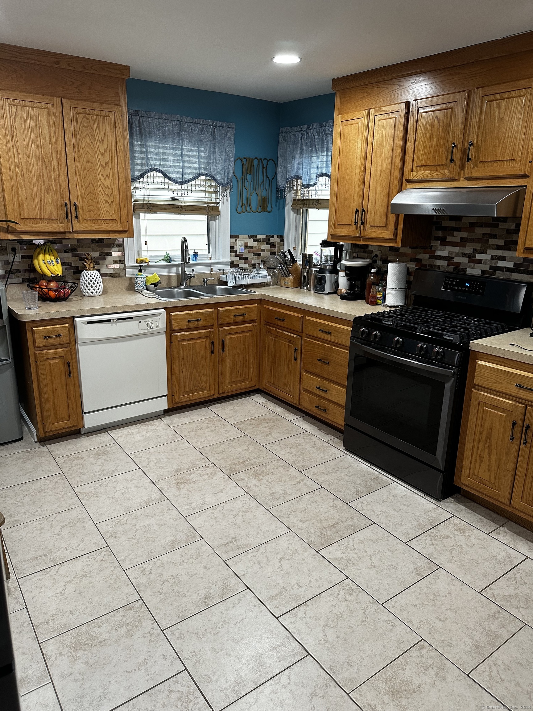 504 Dixwell Avenue New Haven, CT 06511 - Photo 5 of 26 a kitchen with stainless steel appliances granite countertop a stove a sink dishwasher and a refrigerator