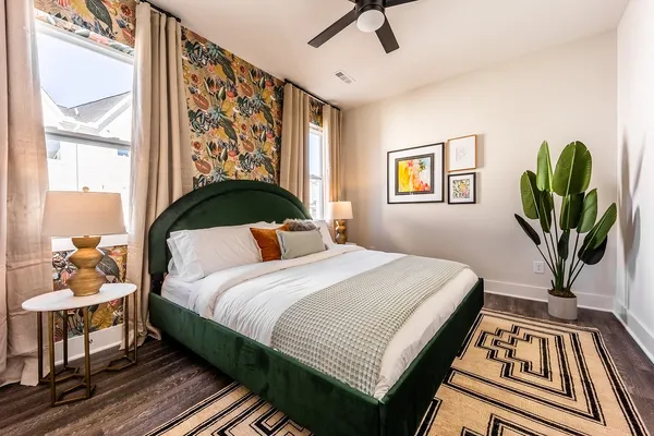 a bedroom with a bed and wooden floor
