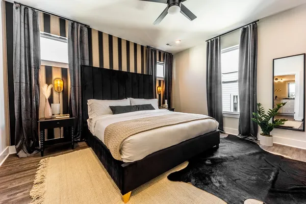 a bed sitting in a bedroom next to a window