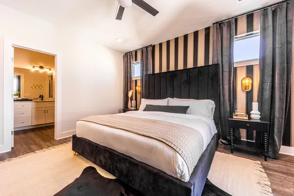 a bedroom with a bed and a flat screen tv