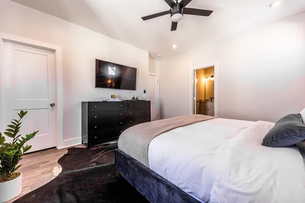 a bedroom with a bed and a flat screen tv