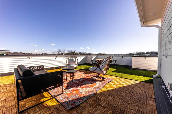 a terrace with outdoor seating and city view