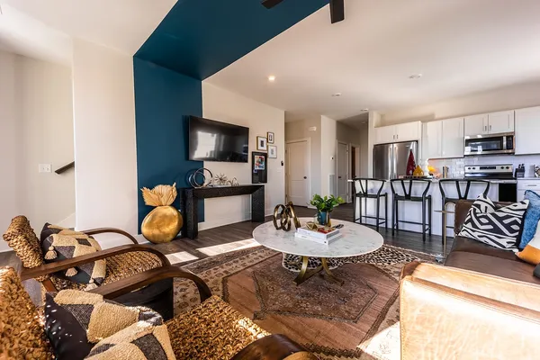 a living room with lots of furniture and wooden floor