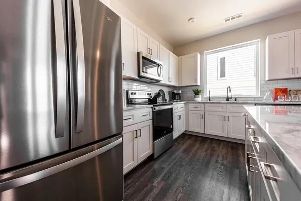 a kitchen with a sink window and cabinets