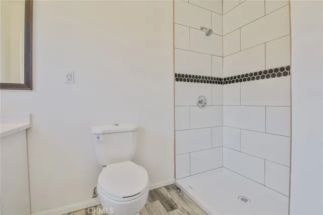 a bathroom with a toilet and a shower