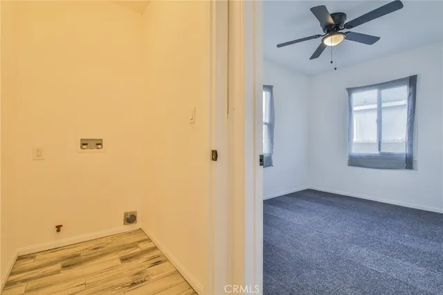 a view of a room with a ceiling fan and a window