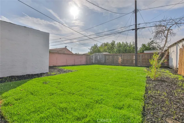 a view of a house with a yard and a garden
