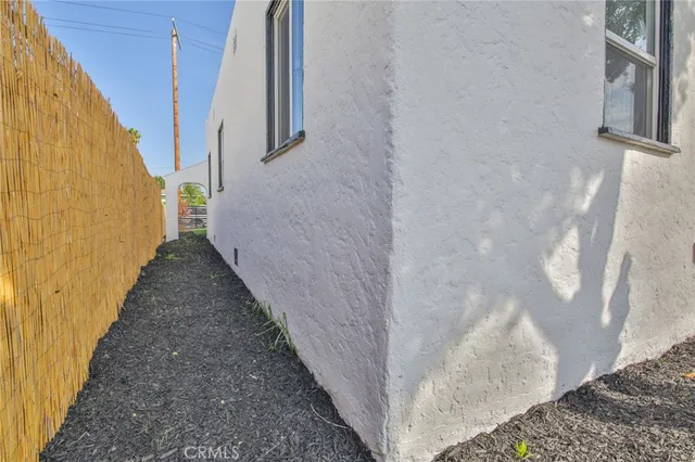 a view of yard with swimming pool and wooden fence