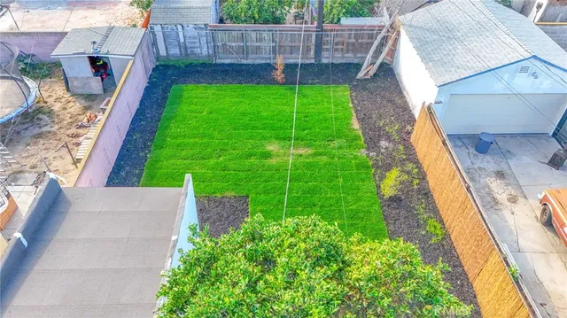 an aerial view of a house with pool and furniture