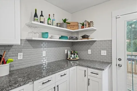 a kitchen with a sink a stove and cabinets
