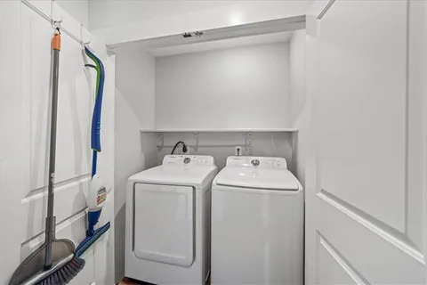 a view of storage and utility room with washer and dryer