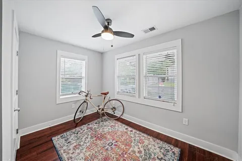 a view of a livingroom with wooden floor and a window
