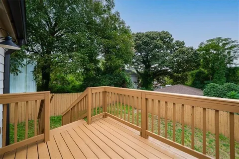 a view of deck with furniture and trees around