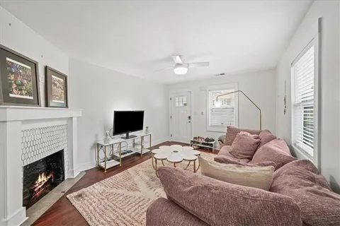 a living room with furniture a fireplace and a flat screen tv