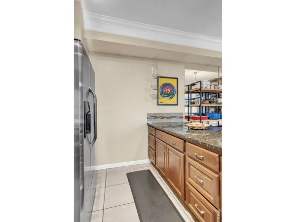 a kitchen with stainless steel appliances granite countertop a refrigerator and a stove top oven