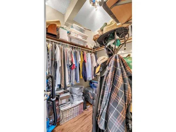 a view of walk in closet with clothes