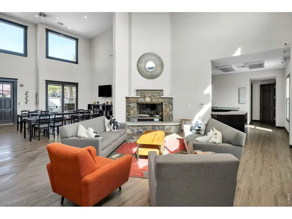 a living room with furniture kitchen view and a fireplace