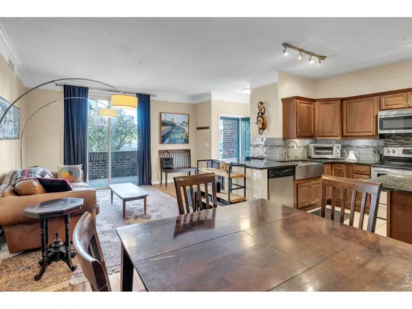 a dining room with furniture and a kitchen view
