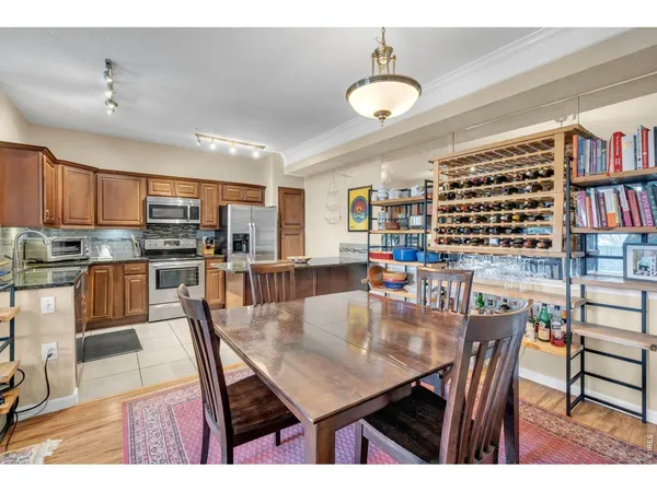 a dining room with furniture and a kitchen view