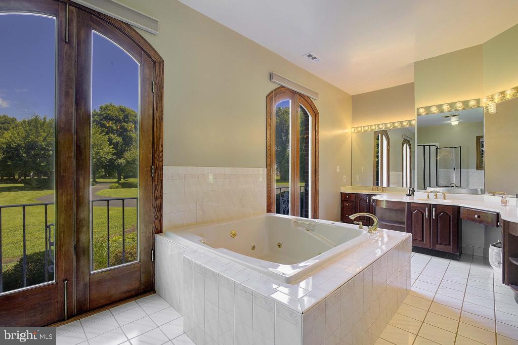 3330 Soper Road Huntingtown, MD 20639 - Photo 54 of 75 a white bath tub sitting in a bathroom and sink