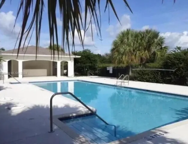 a view of swimming pool with a chair and tables