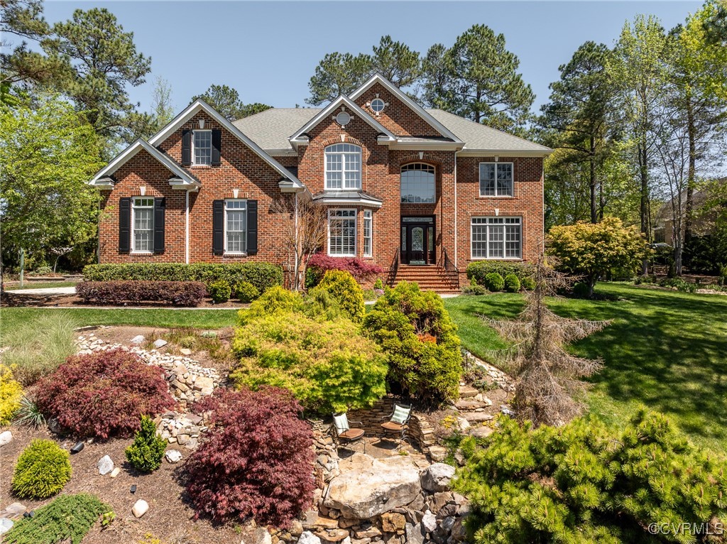 a front view of a house with a garden