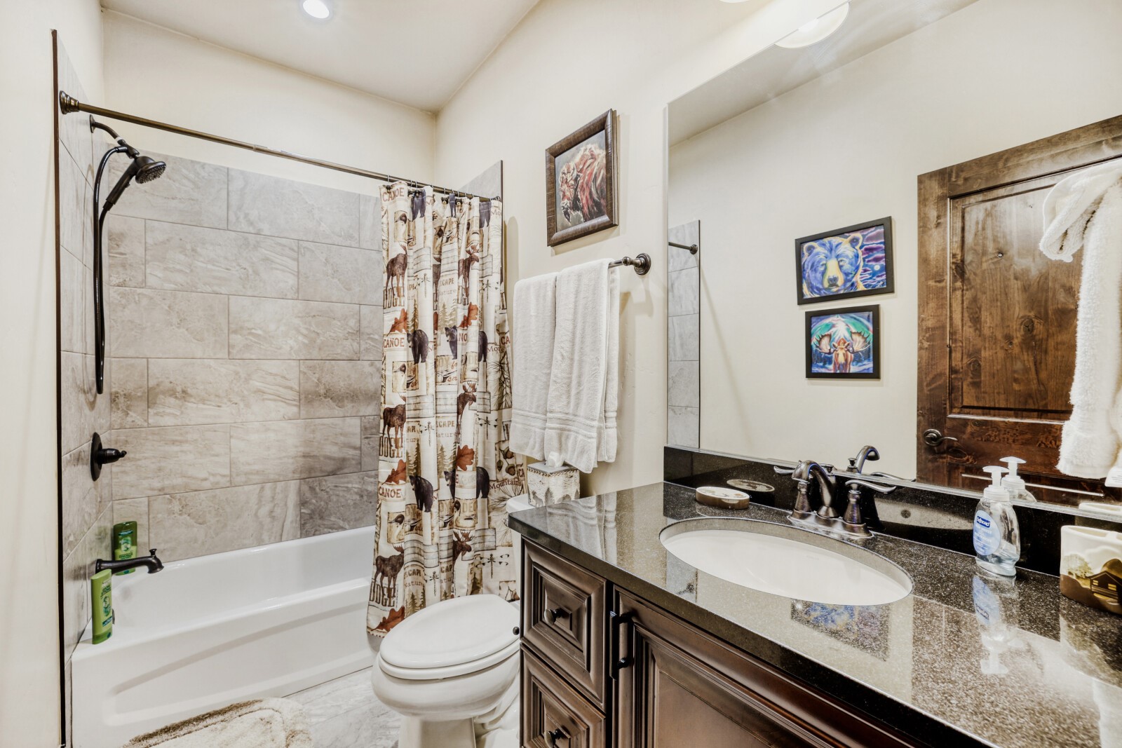 852 Independence Road, Unit B Keystone, CO 80435 - Photo 27 of 40 a bathroom with a granite countertop sink a toilet a mirror a vanity a bath tub and shower
