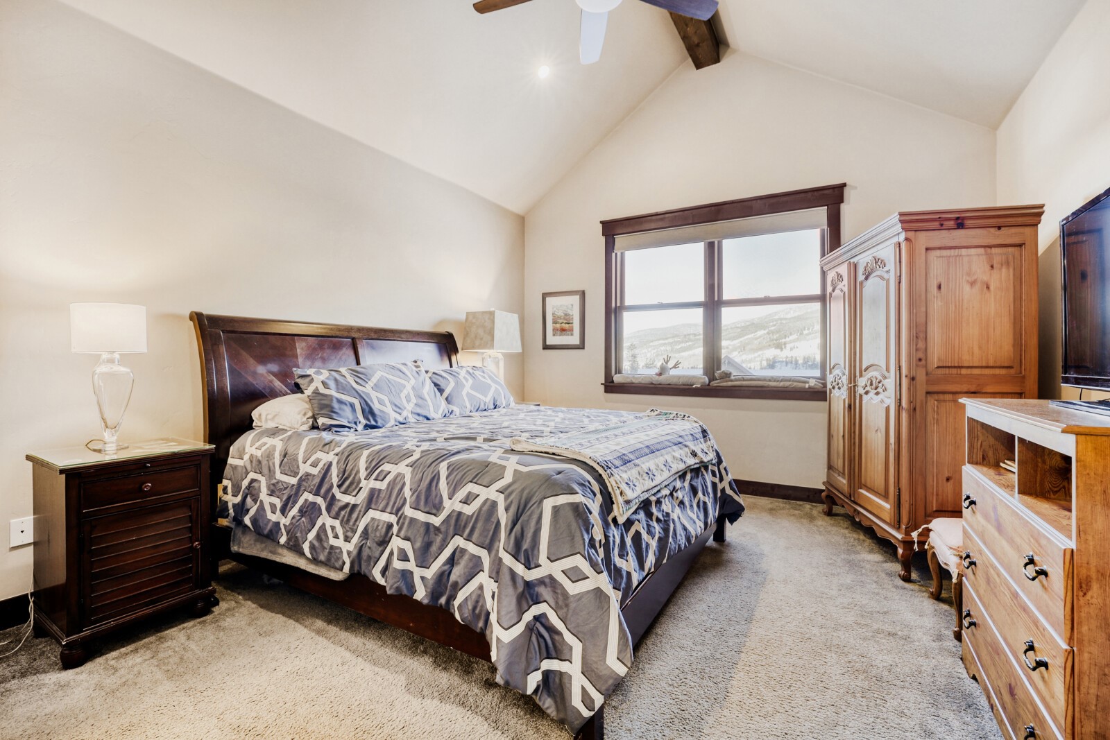 852 Independence Road, Unit B Keystone, CO 80435 - Photo 7 of 40 a bedroom with a bed a dresser and next to a window