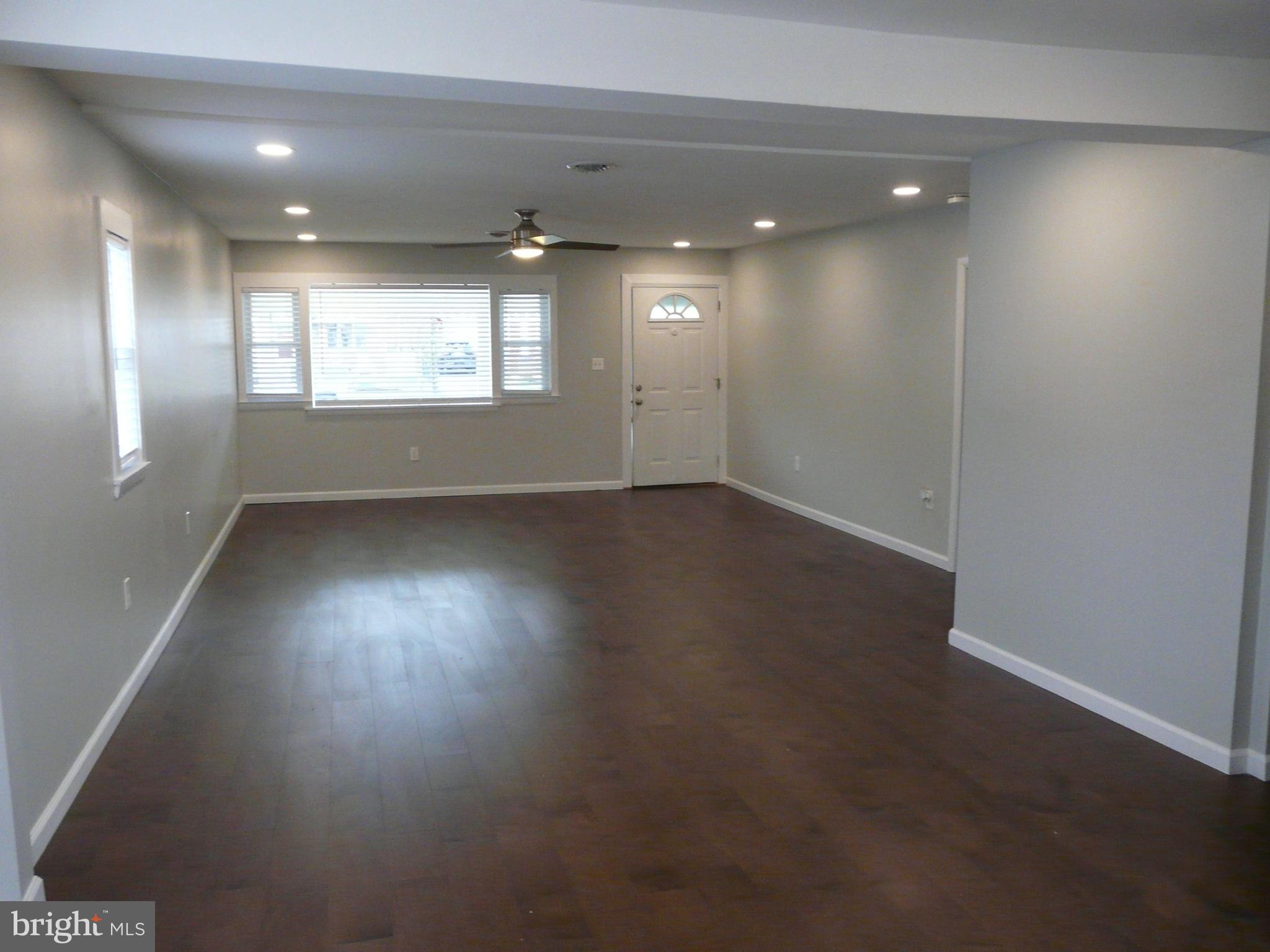 1009 Fuselage Avenue Middle River, MD 21220 - Photo 4 of 28 an empty room with wooden floor and windows