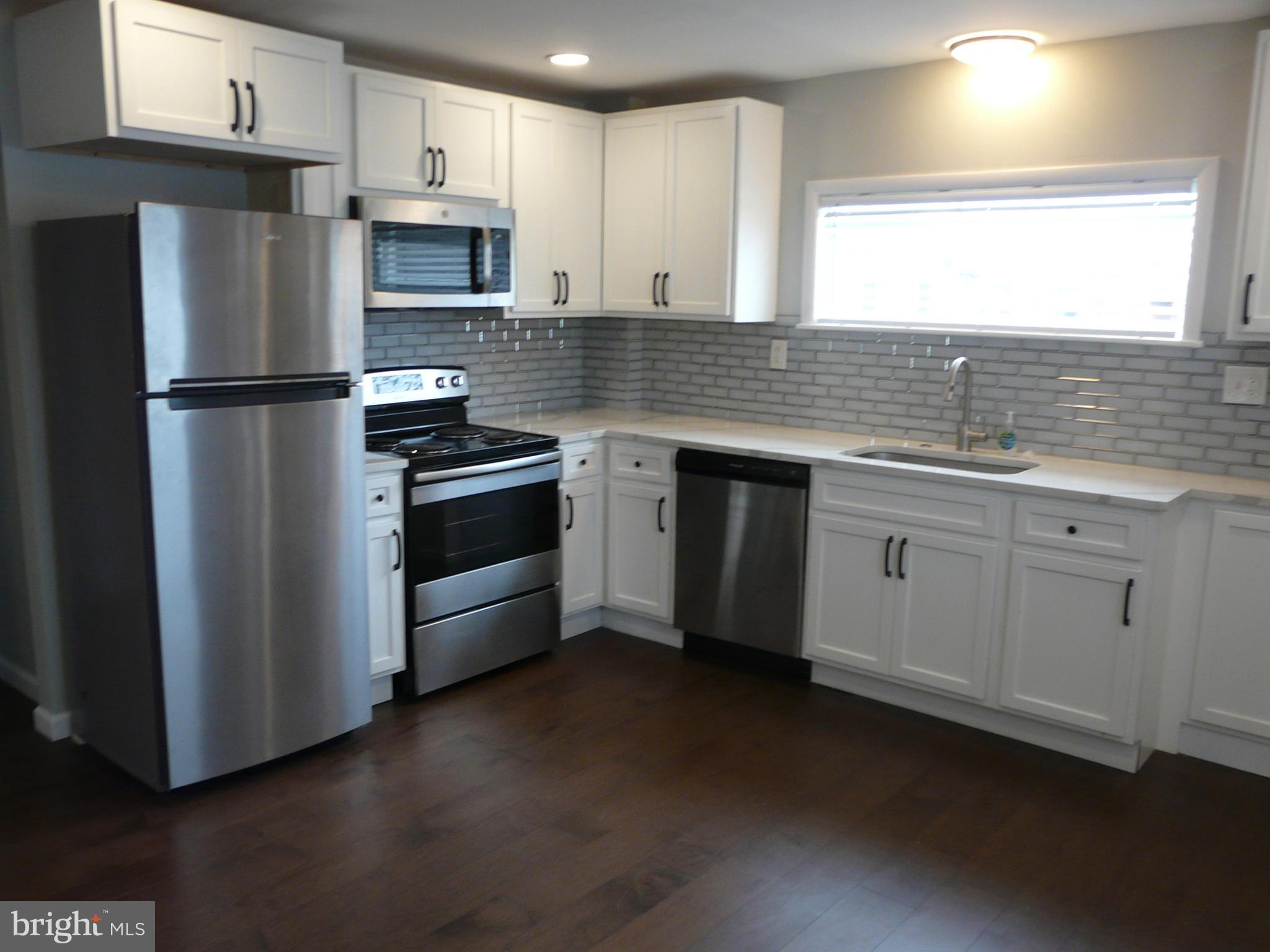 1009 Fuselage Avenue Middle River, MD 21220 - Photo 7 of 28 a kitchen with appliances cabinets and a sink
