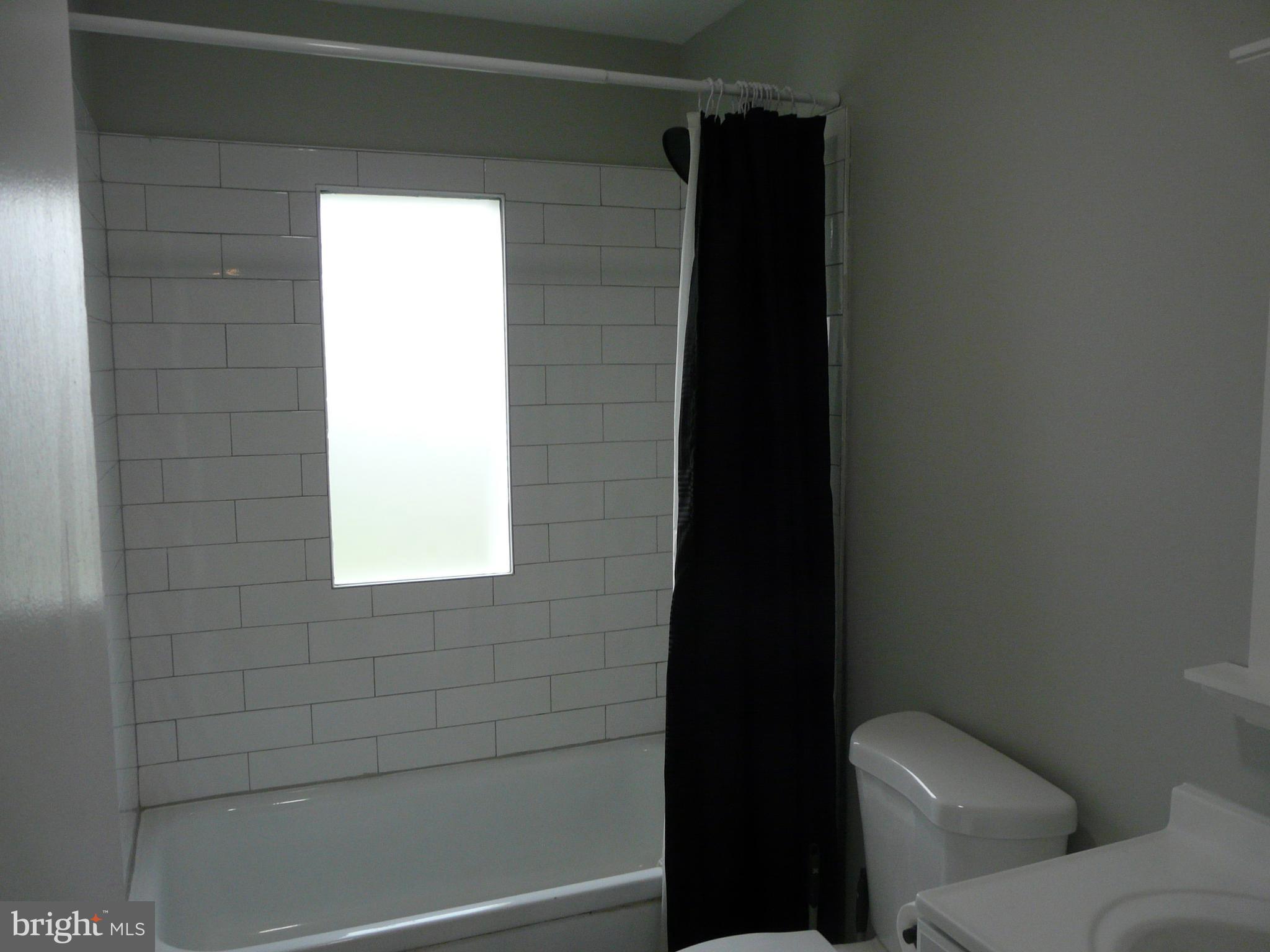 1009 Fuselage Avenue Middle River, MD 21220 - Photo 9 of 28 a bathroom with a toilet and a shower