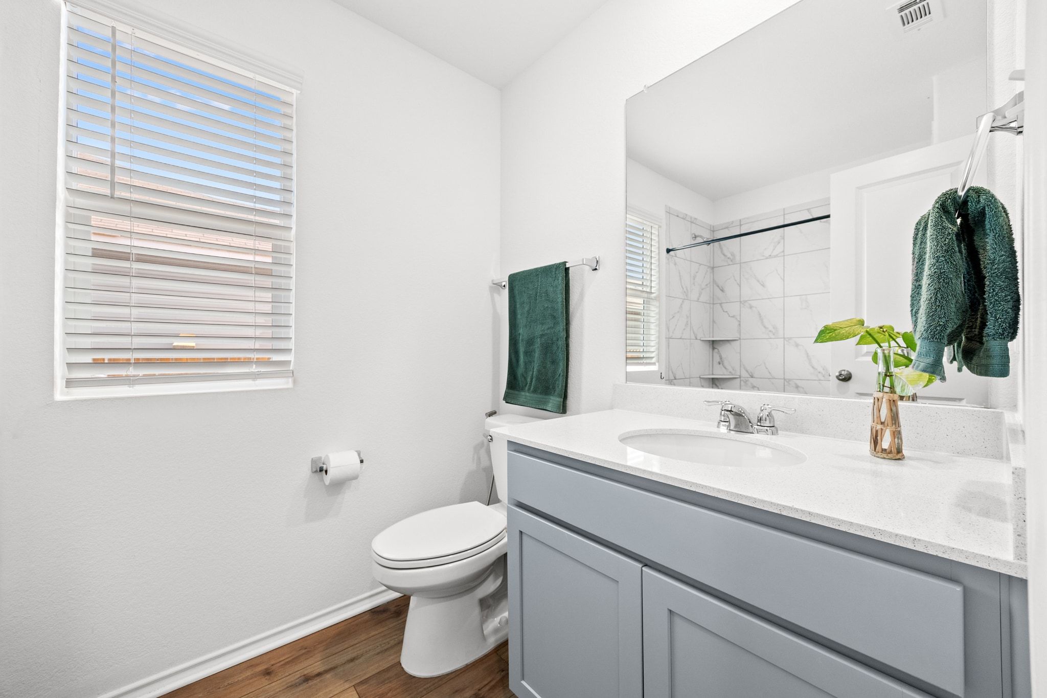124 Perfect World Loop Jarrell, TX 76537 - Photo 15 of 32 a bathroom with a sink a toilet and mirror